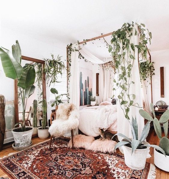 26-a-boho-rug-lots-of-greenery-and-cacti-faux-fur-and-a-canopy-bed-for-a-welcoming-boho-bedroom.jpg